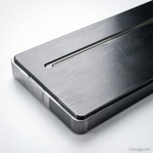 CNC machine precisely cutting aluminum keyboard housing with real-time tolerance display